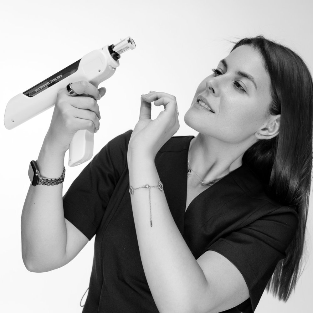 Yulia Agranovych with a microneedling device, black-and-white photograph